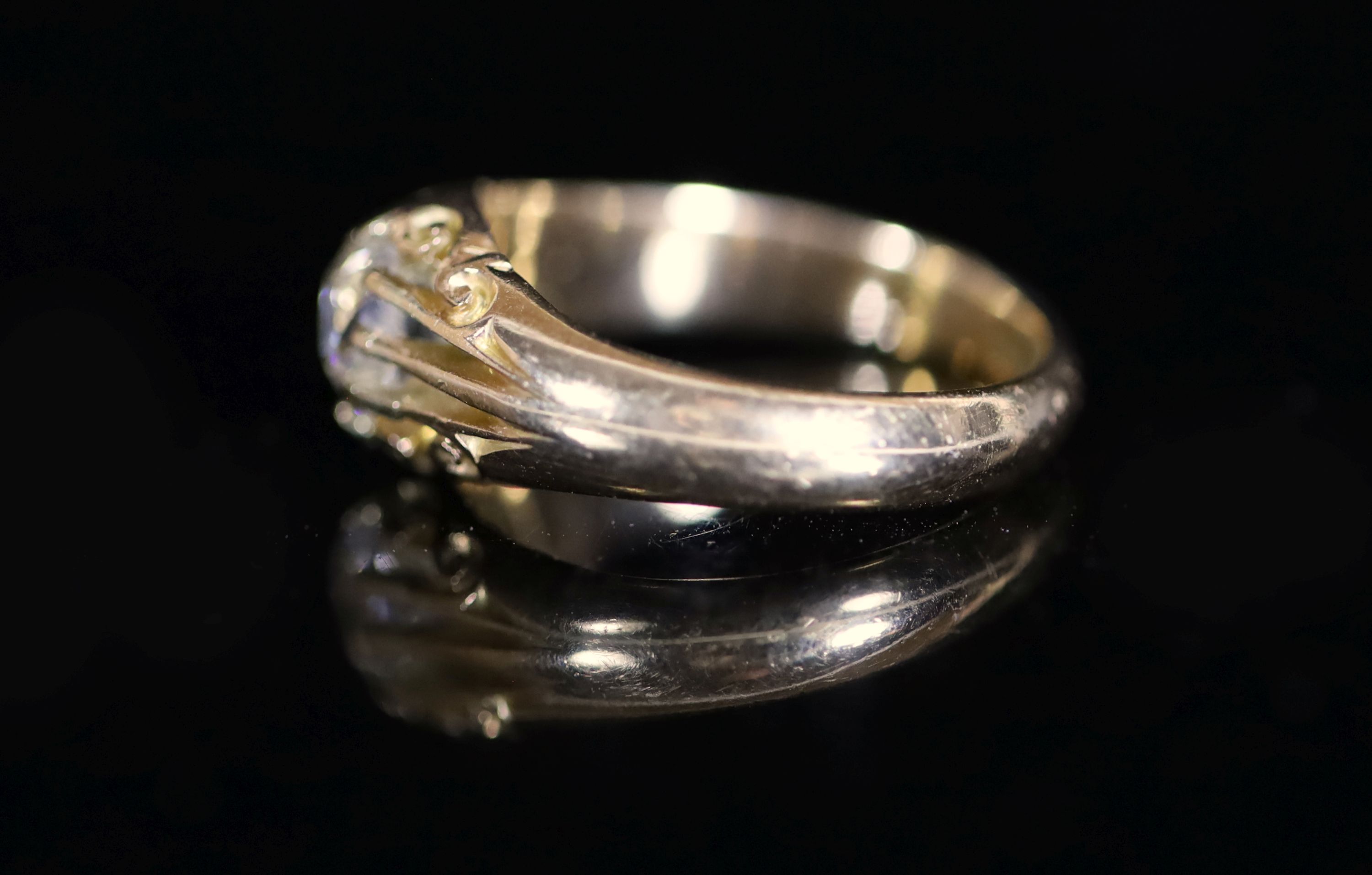 An early 20th century 18ct gold and claw set solitaire diamond ring